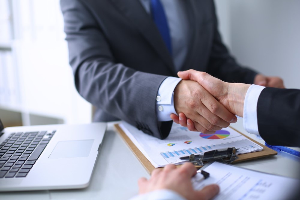 Business handshake. Business people shaking hands, finishing up a meeting
